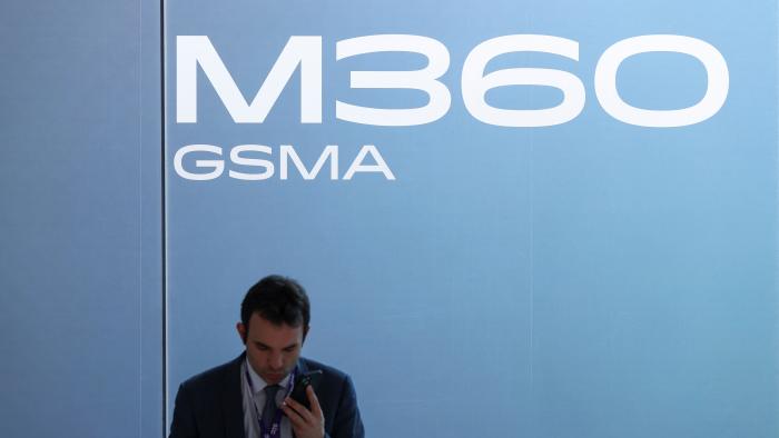 A man uses a mobile phone, as he attends the Mobile World Congress (MWC) in Barcelona, Spain, February 27, 2024. REUTERS/Bruna Casas