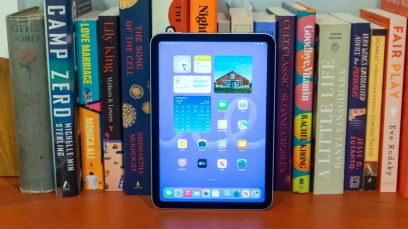 A tablet resting against books.