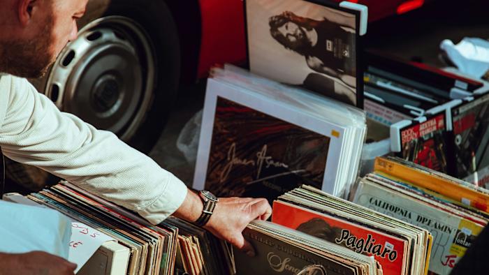 A person looks through some vinyl records.