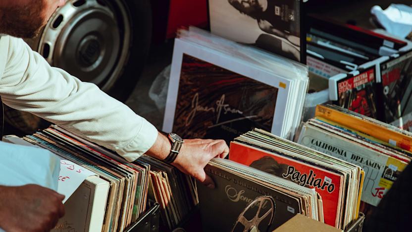 A person looks through some vinyl records.