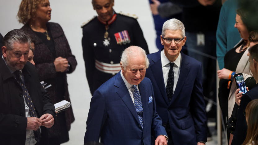 Britain's King Charles and CEO of Apple, Tim Cook walk at Apple's UK Head Office at Battersea Power Station in London, Britain, December 12, 2024. REUTERS/Toby Melville