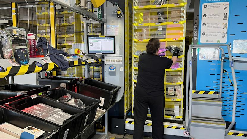 An Amazon worker places a product on a shelf for storage, at an Amazon warehouse, which opened in August 2021, in Dartford, Kent, Britain May 3, 2023. REUTERS/Helen Reid