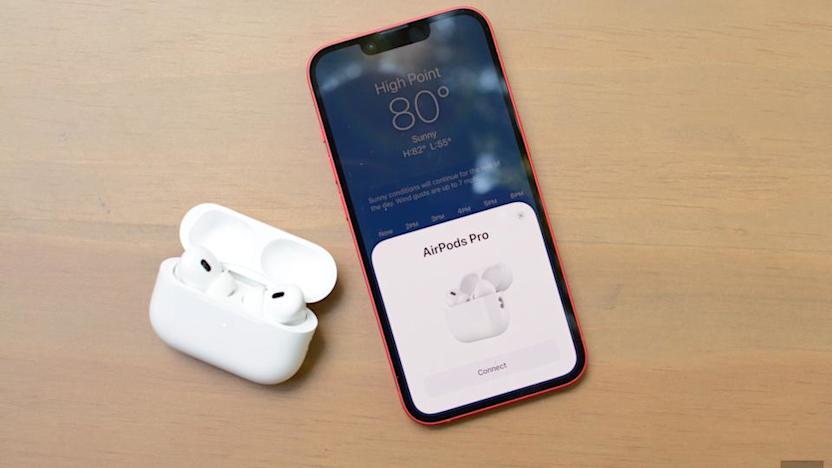 A pair of 2nd Gen AirPods Pro next to an iPhone.