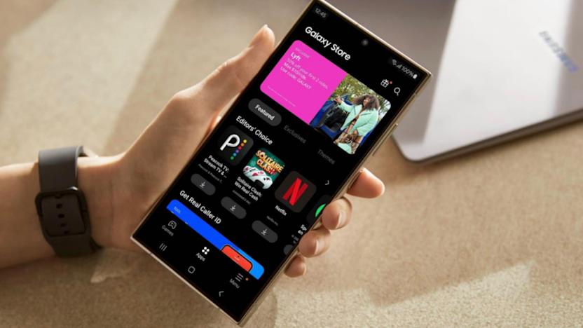 A hand holding a phone with its open showing the Samsung Galaxy Store.