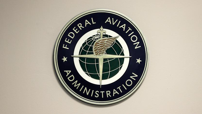 FILE - A Federal Aviation Administration sign hangs in the tower at John F. Kennedy International Airport in New York, March 16, 2017. (AP Photo/Seth Wenig, File)