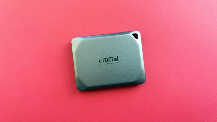 The Crucial X9 Pro portable against a red background.