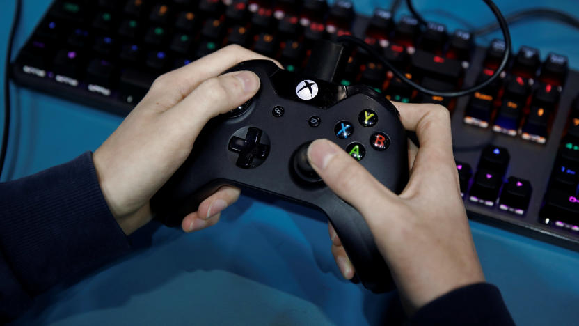 An attendee uses a Microsoft Xbox One controller while playing a video game at the Paris Games Week (PGW), a trade fair for video games in Paris, France, October 29, 2019. REUTERS/Benoit Tessier