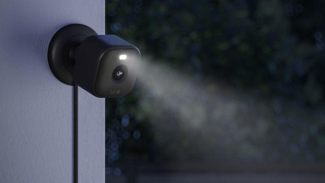 Image of the Blink Mini 2 outdoors with its LED spotlight activated.