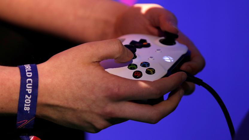 A player holds his gaming controller as he  competes in the FIFA 2018 eClub World Cup qualifiers in Paris, France, May 19, 2018. REUTERS/Philippe Wojazer