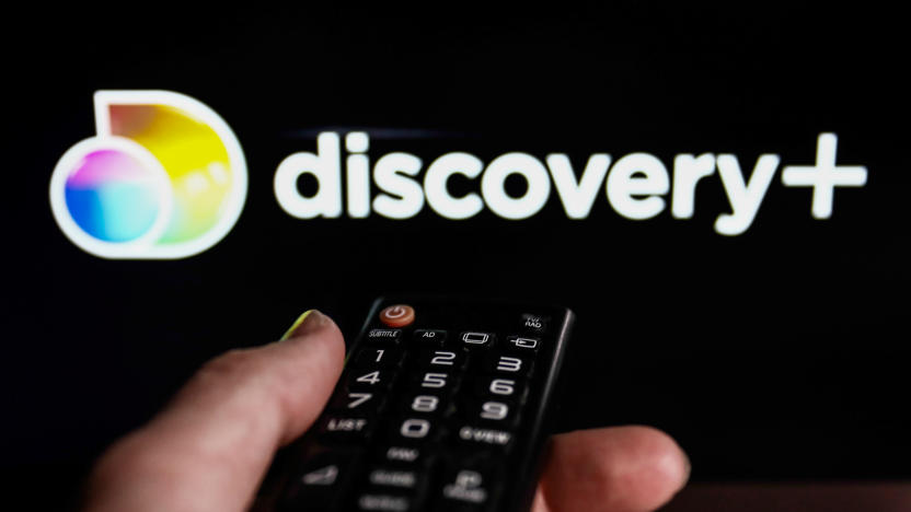 TV remote control and Discovery+ logo displayed on a laptop screen are seen in this illustration photo taken in Krakow, Poland on February 9, 2022. (Photo illustration by Jakub Porzycki/NurPhoto via Getty Images)