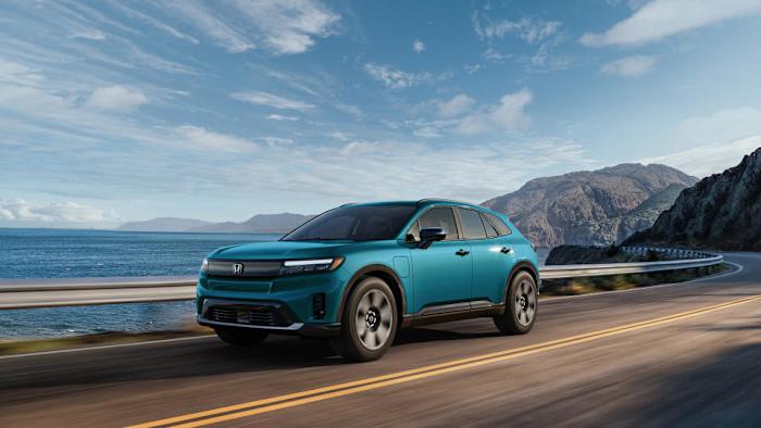 A blue Honda Prologue electric SUV driving down the Pacific Coast Highway.