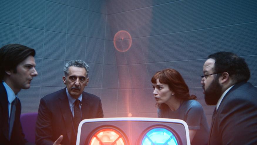 A still from the second season of Apple TV+'s Severance, featuring the four main characters sat around a projector.