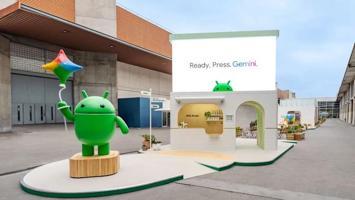 The Android mascot stands in front of a Gemini AI kiosk in Barcelona. 