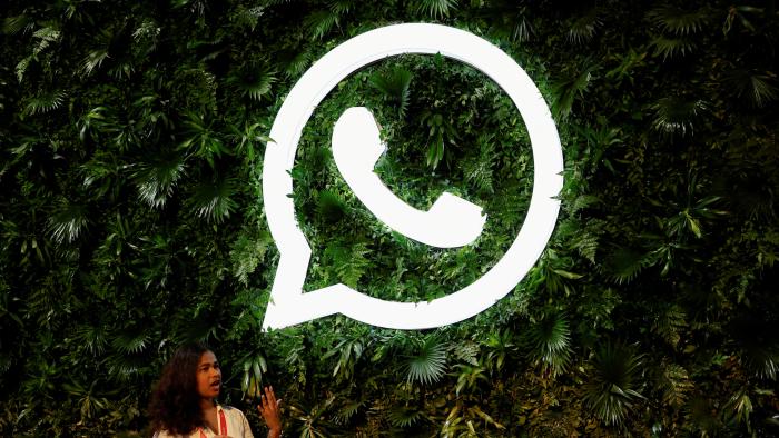 FILE PHOTO: A woman stands next to a logo of messaging application Whatsapp during a Meta conference in Mumbai, India, September 20, 2023. REUTERS/Francis Mascarenhas/File Photo