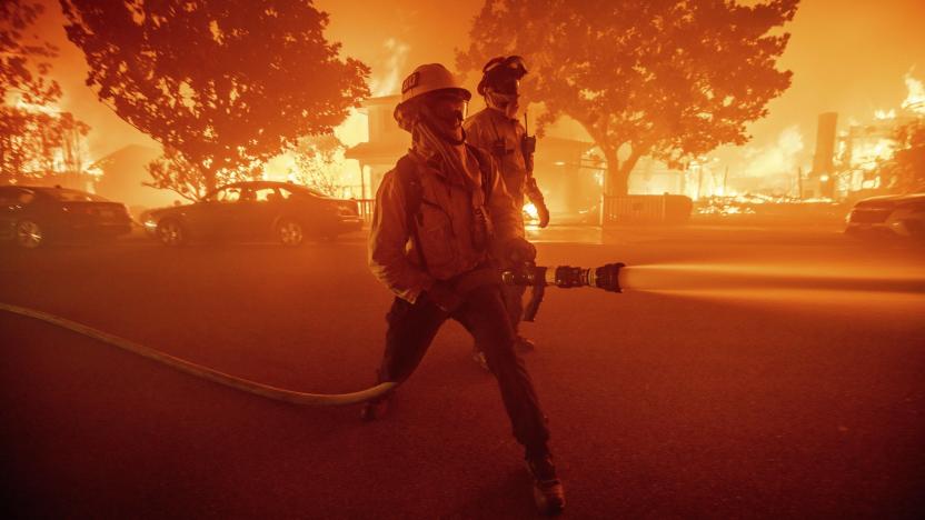 FILE - Firefighters battle the Palisades Fire as it burns multiple structures in the Pacific Palisades neighborhood of Los Angeles, Tuesday, Jan. 7, 2025. (AP Photo/Ethan Swope, File)
