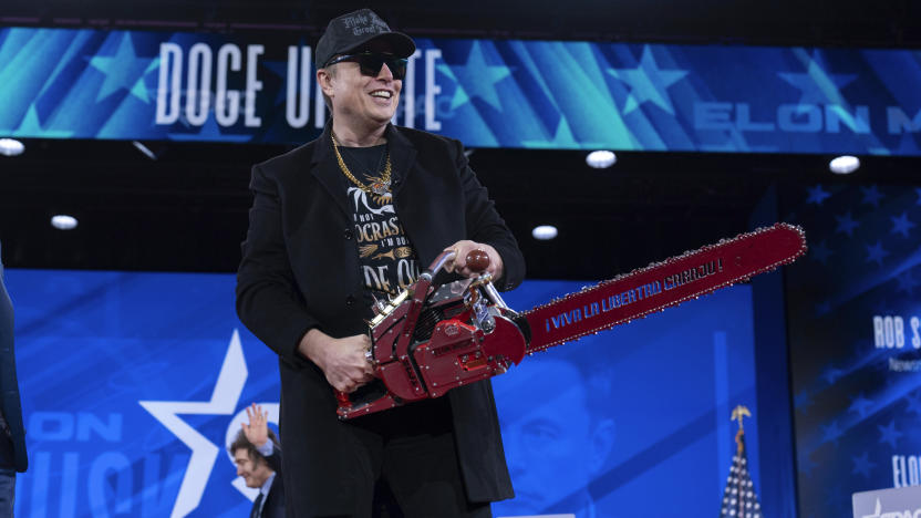 Elon Musk hold a chainsaw as he arrives to speak at the Conservative Political Action Conference, CPAC, at the Gaylord National Resort & Convention Center, Thursday, Feb. 20, 2025, in Oxon Hill, Md. (AP Photo/Jose Luis Magana)